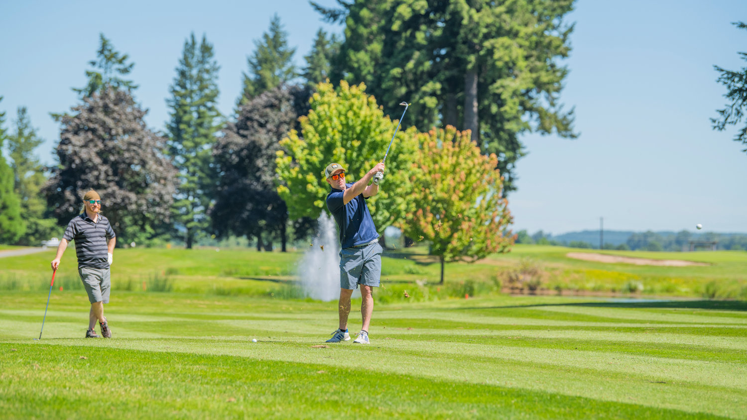 Aaron Van Tuyl makes contact as he swings his club during a charity golf tournament at Riverside Golf Course in Chehalis on Friday.